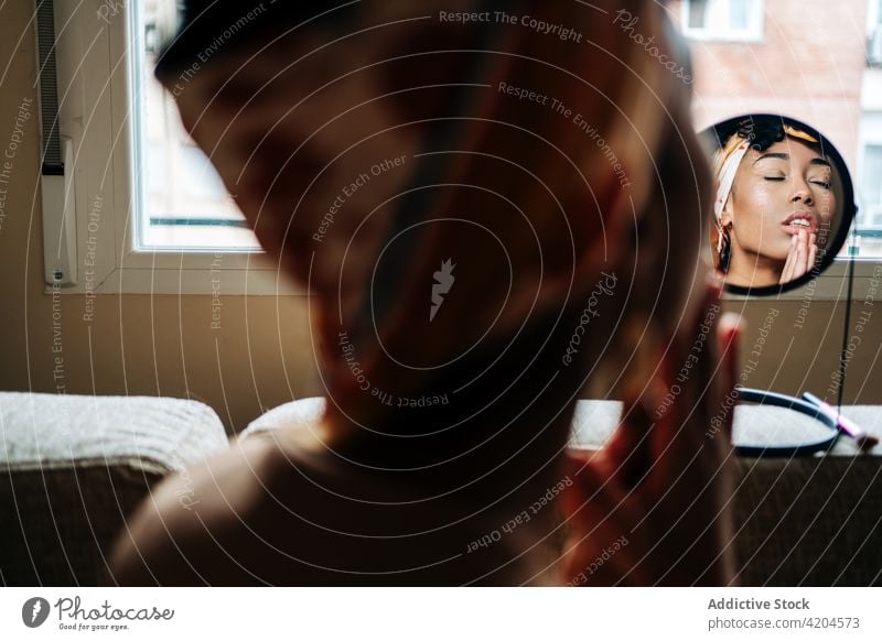 Black woman praying with closed eyes at home prayer faith belief religion eyes closed hands clasped spirit female ethnic black african american mirror reflect