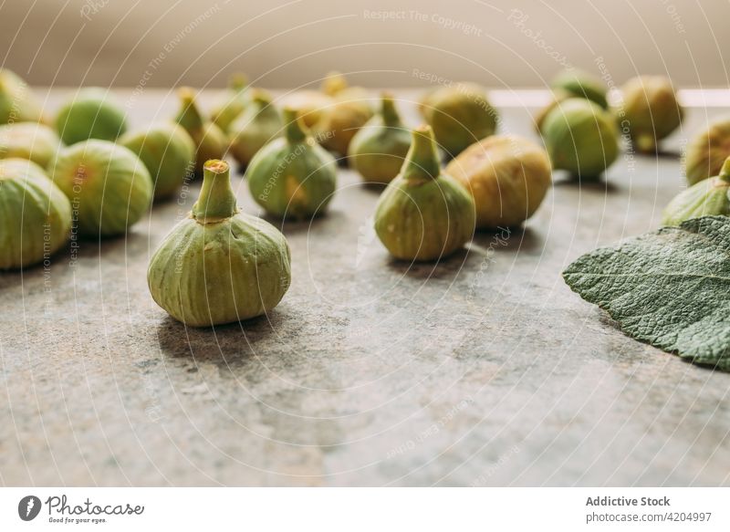 Ripe sweet green figs, freshly harvested from domestic tree, on table with grunge texture. fruit ripe organic food diet nature healthy juicy raw freshness