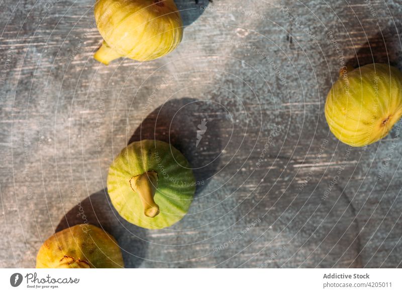 Ripe sweet green figs, freshly harvested from domestic tree, on table with grunge texture. fruit ripe organic food diet nature healthy juicy raw freshness