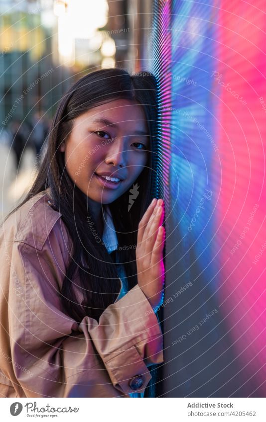 Pensive woman near neon light on street dreamy town calm pensive thoughtful sign ponder female appearance confident contemporary individuality emotionless