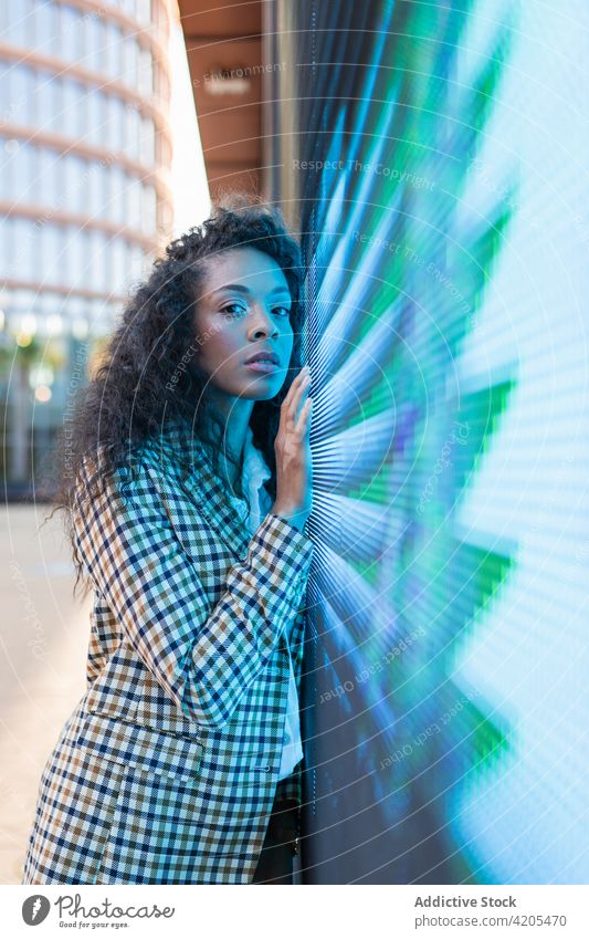 Pensive woman near neon light on street dreamy town calm pensive thoughtful sign ponder female appearance confident contemporary individuality emotionless