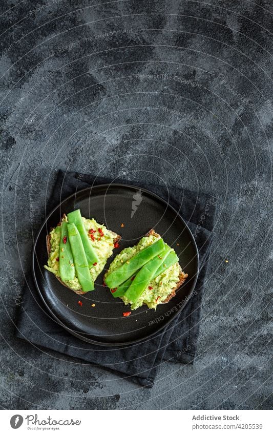 Delicious toasts with guacamole and green pea pods delicious tasty serve appetizing yummy eat vegetarian meal organic cuisine nutrition vegetable fresh dish