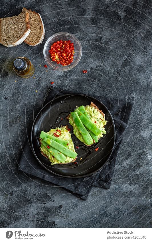 Delicious toasts with guacamole and green pea pods delicious tasty appetizing yummy eat vegetarian meal organic cuisine nutrition vegetable fresh dish garnish