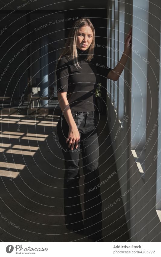 Portrait of a young blonde girl by the window woman Russian girl alone beautiful blue eyes city city life cityscape day downtown elegant female formal long hair