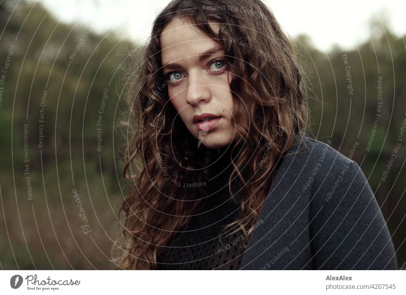 Portrait of a young woman with long, brunette, curly hair in front of a moor landscape Woman Young woman 18 - 30 years pretty Beauty & Beauty long hairs Curl