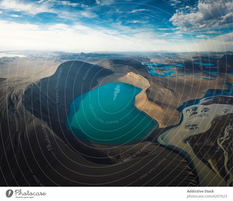 Scenic view of blue pond surrounded by rocky formations lake mountain scenery range wonderful nature ridge volcanic highland iceland environment reservoir