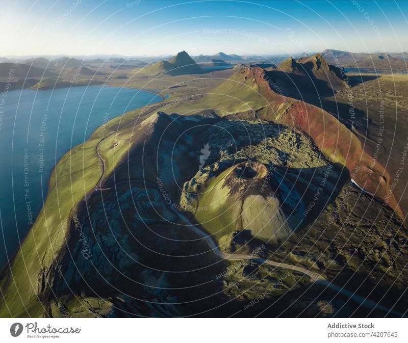 Scenic view of blue pond surrounded by rocky formations lake mountain scenery range wonderful nature ridge volcanic highland iceland environment reservoir