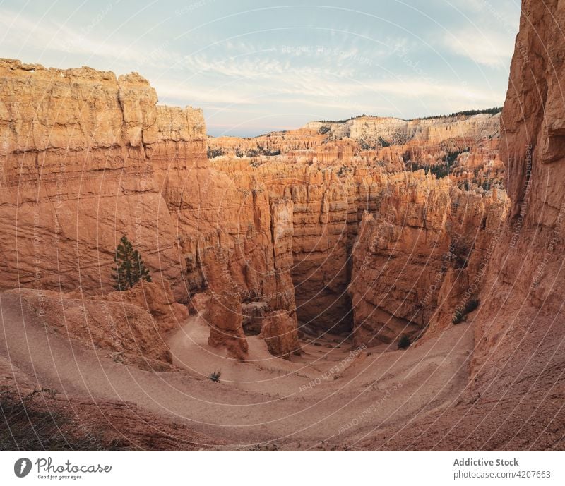 Rocky formations in desert terrain in USA rocky bryce canyon nature national park landscape cliff scenery cloudy usa united states america sightseeing tall