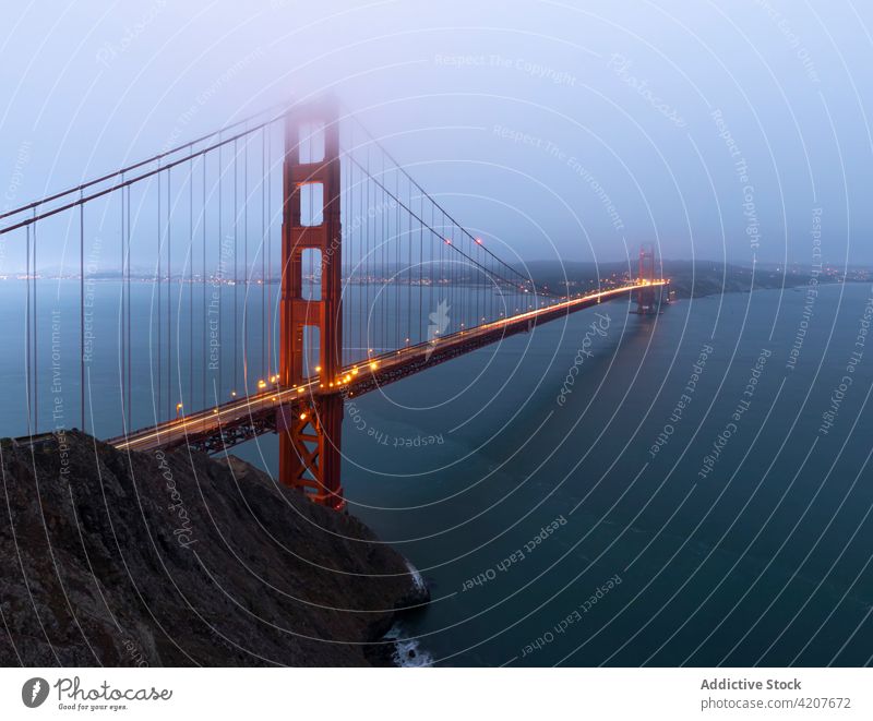 Suspension bridge over sea in USA golden gate suspension water coastal mist evening glow fog calm san francisco usa america illuminate light waterfront haze