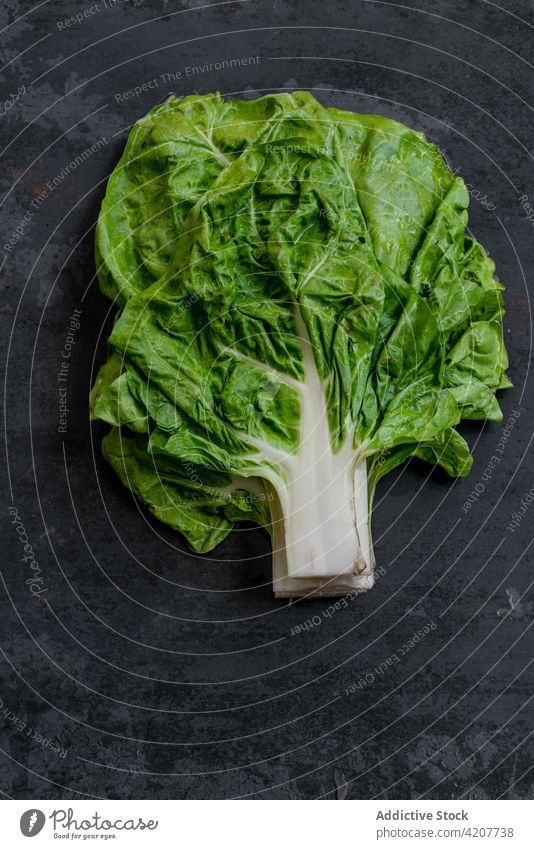 Bunch of fresh chard on black table bunch vegetable ripe harvest vitamin food healthy organic natural edible nutrition shabby weathered grunge vegetarian raw