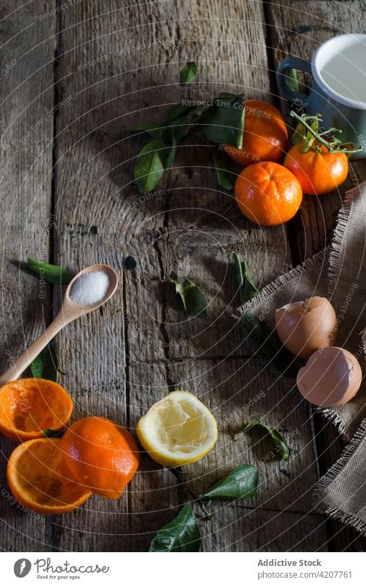 Ingredients for tangerine mousse on wooden table ingredient fresh citrus fruit dessert recipe healthy tasty kitchen sugar eggshell cup lemon peel home