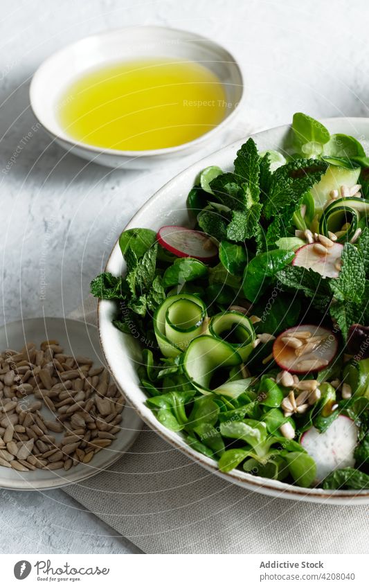 Bowl with healthy salad on table vegetable lunch food bowl fresh organic natural serve olive oil sunflower seed meal tasty appetizing yummy nutrition