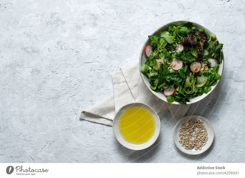 Bowl with healthy salad on table vegetable lunch food bowl fresh organic natural serve olive oil sunflower seed meal tasty appetizing yummy nutrition