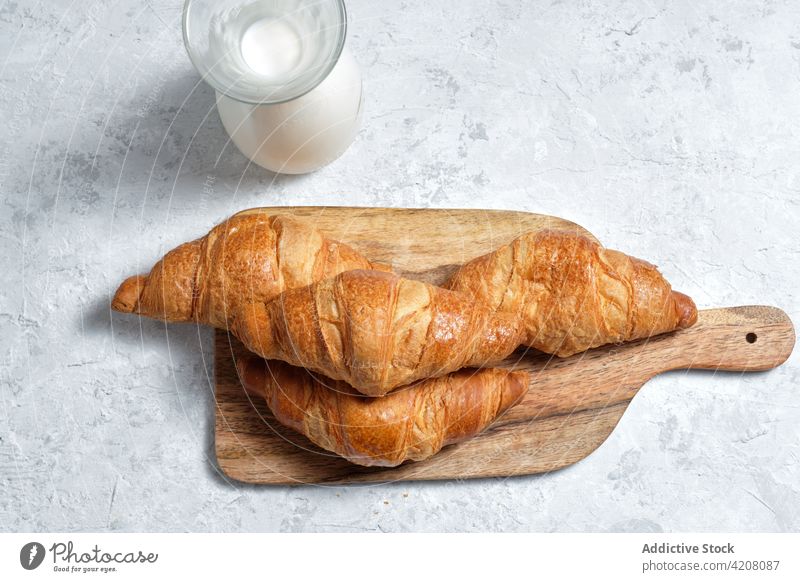 Tasty croissants on table at home milk breakfast kitchen tasty morning fresh baked meal food dairy beverage pastry bottle delicious drink dessert appetizing