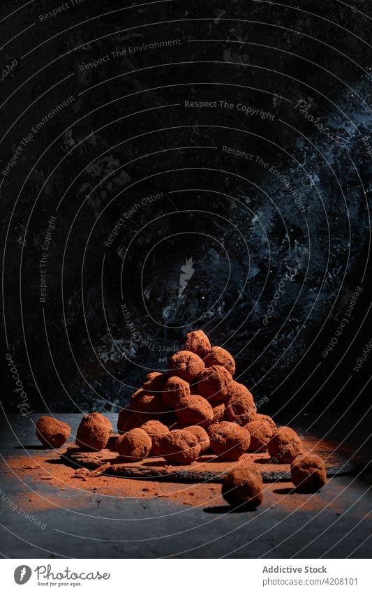 Pile of tasty chocolate truffles on dark background candy ball sweet dessert treat pile studio yummy table nutrition sugar appetizing gourmet food heap