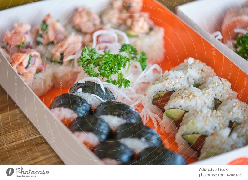 Detail of Box with Varied Sushi top view sushi rice salmon seaweed fish seafood japonese food variety many delicious yummy japanese food nagiri rolls macro