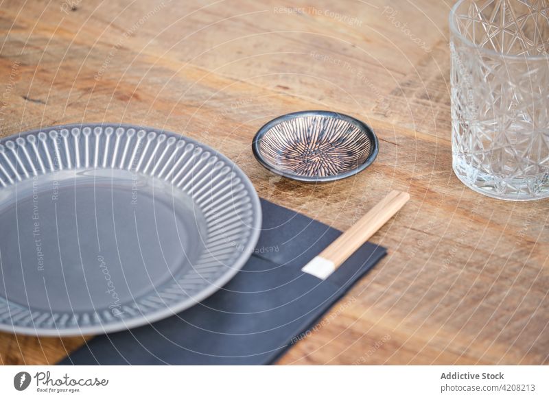 Plate and Chopstick in Japanese Restaurant plate chopsticks glass table restaurant japanese japanese restaurant ready prepared front view wooden table meal