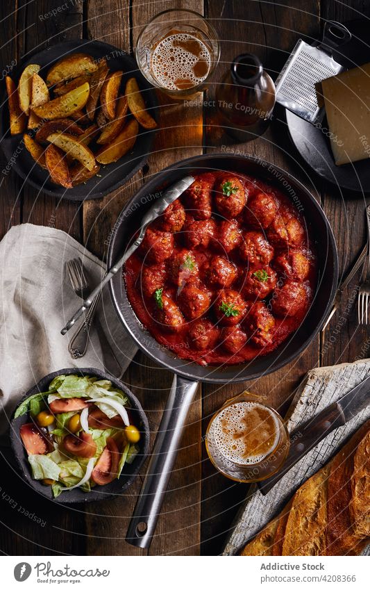 Closeup viewed from above of a plate of meatloaf with tomato meatballs dinner food parsley beef sauce homemade red traditional lunch meal tasty rustic delicious