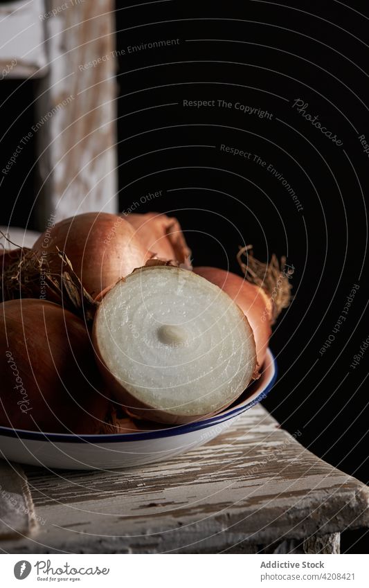 Bunch of onions in bowl chair vegetable organic unpeeled half whole dark shabby rustic food healthy fresh ingredient natural vegan ripe raw vitamin edible