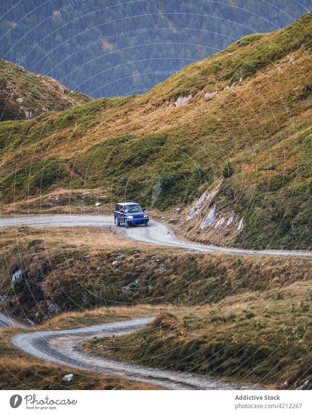 Car driving on road in highlands car road trip travel hill nature drive pyrenees countryside transport mountain tourism modern dusty forest daylight spain