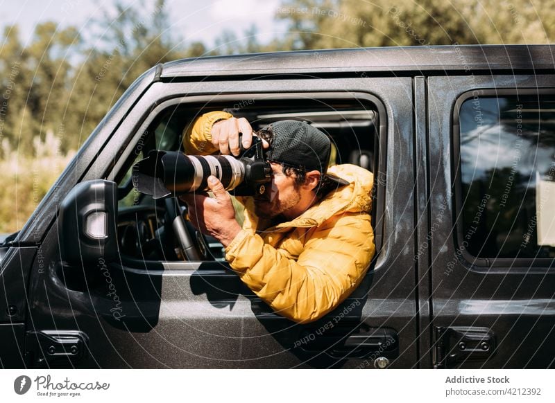 Adventurous photographer taking photos with his off-road car man adventure camera people photography adult lifestyles nature outdoors exploration transportation