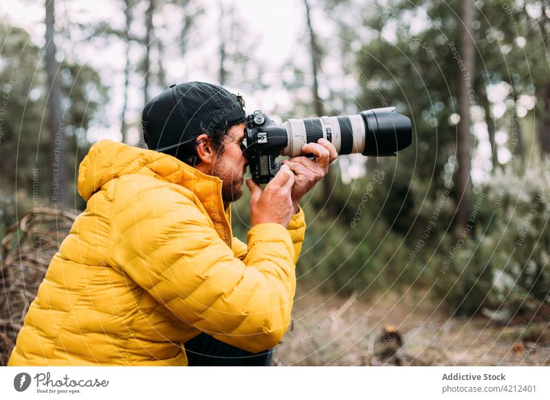 Adventurous photographer taking photos in the mountain man adventure camera people photography adult lifestyles nature outdoors exploration transportation