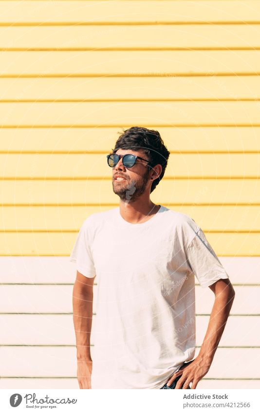 Stylish man in sunglasses standing near bathing box summer sunny enjoy content vacation happy male melbourne australia relax freedom summertime trendy positive