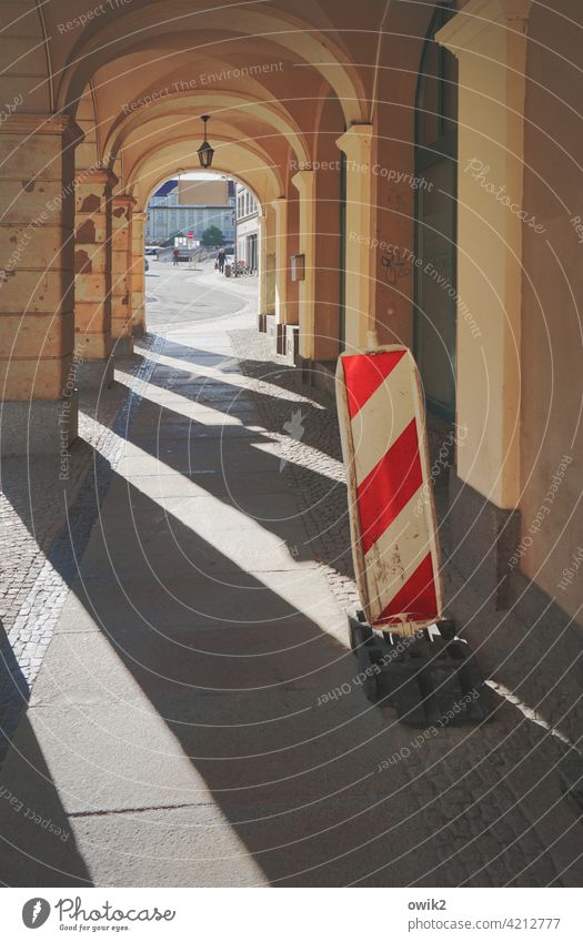 review Tunnel Arcade Passage columns Sidewalk Sunlight Shadow Diagonal Countdown marker Warning sign Reddish white Vista Tunnel vision