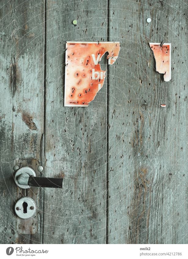 Incomplete door sign remnants Derelict Old Deserted Colour photo Structures and shapes Detail Exterior shot Close-up Ravages of time Damage Flake off Bizarre