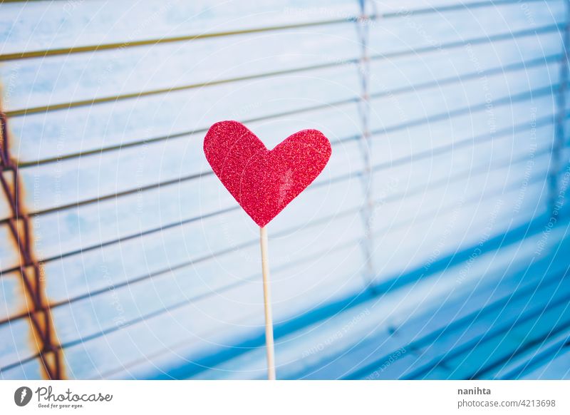 Red heart against a blue blinde background love valentine valentine's day heart shape red heart lovely adorable color glitter brilliant vibrant colorful cute