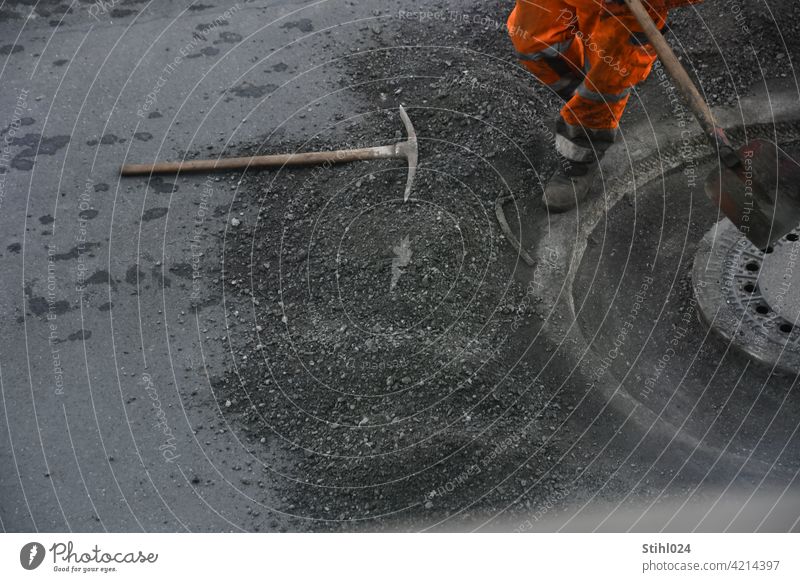 Road construction worker with orange pants and shovel roadman Working man Shovel Orange Pants reflective labour mortising Manhole cover manhole asphalt work