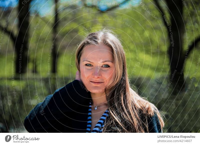 Young woman in the city park looking at the camera action alone background blond blue eyes body part citizen city-park close-up copy space dame day daylight