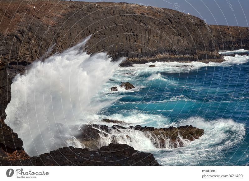 foul Environment Nature Landscape Water Sky Cloudless sky Sunlight Weather Beautiful weather Wind Hill Rock Waves Coast Bay Ocean Blue Brown White Surf Inject