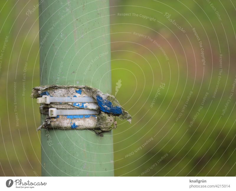 Two cable ties tied around a lamppost Lamp post Cable strap Fastening Close-up Colour photo Exterior shot Deserted Day Detail Metal Safety Structures and shapes