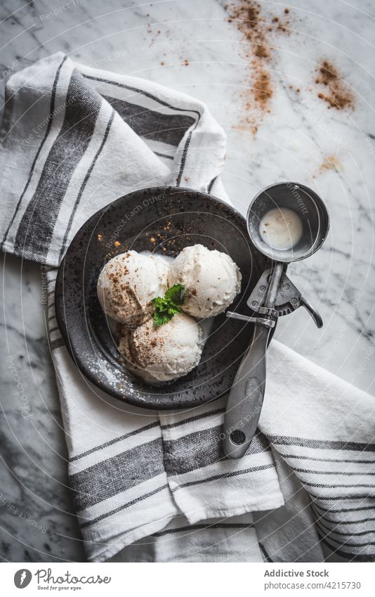 Delicious meringue milk ice cream on plate dessert treat sweet cinnamon mint scooper leaf fresh herb gelato tasty powder portion yummy towel delicious ornament