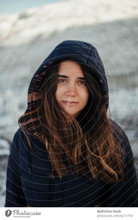 Tourist in outerwear against high ridges in wintertime tourist wanderlust trip mountain vacation feminine hood woman portrait traveler nature highland tourism