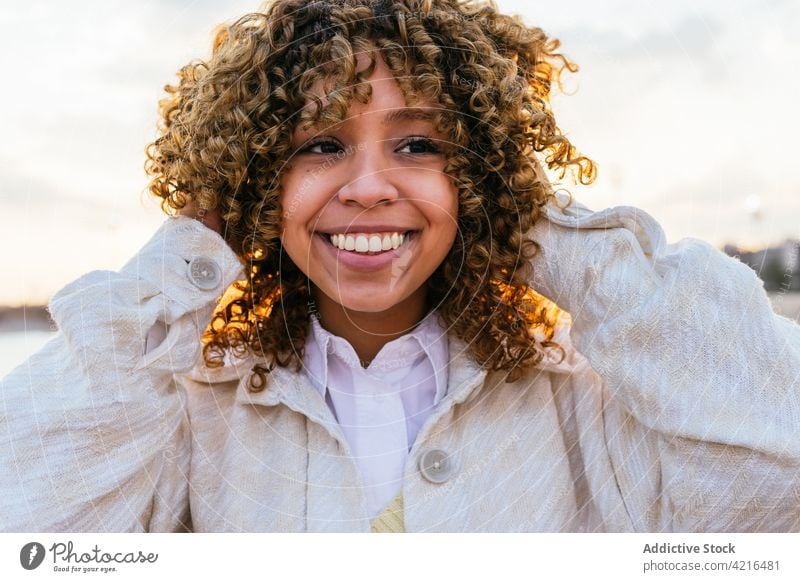 Black woman enjoying freedom at seaside seashore sunset arm cheerful female ethnic black african american summer holiday nature smile evening positive lifestyle