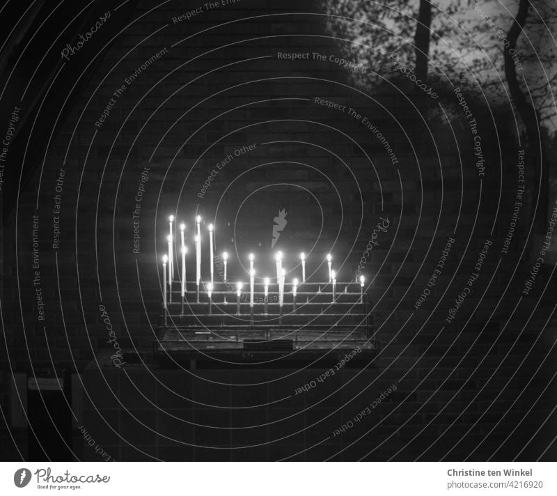 Burning candles in a chapel in the forest with reflection of trees Candle altar Sacrificial candles Sacrificial Lights Hope Belief Prayer shoulder stand