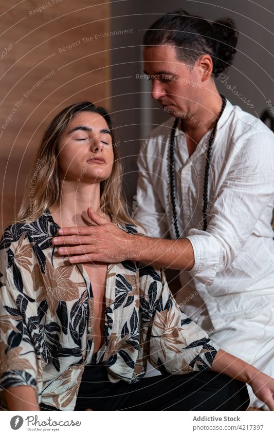 Zen master with woman meditating on plaid teacher meditation yoga practice spirit vitality zen stress relief legs crossed touch chest meditate energy rest