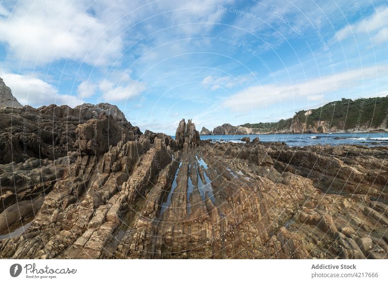 Majestic view of rocky seashore beach formation stone rough coast picturesque asturias spain gueirua beach coastline scenic landscape scenery water sky peaceful