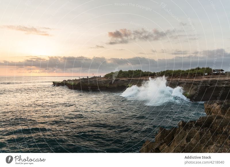 Stormy sea splashing on rocky shore at twilight wave stormy sunset nature seascape picturesque ocean ripple water coast wavy idyllic scenic evening horizon