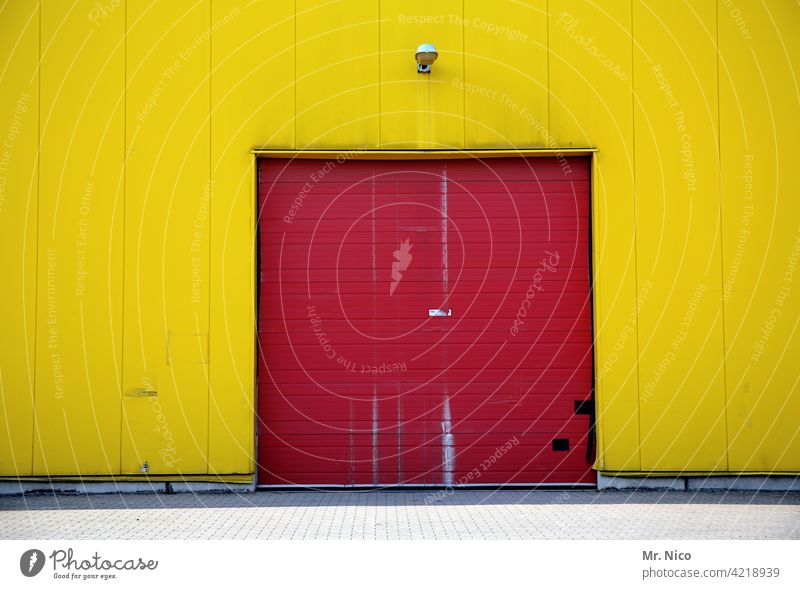 Two-coloured Red Yellow Building Goal Facade Wall (building) Warehouse Depot Trade Workplace Closed Rolling door Stock of merchandise Corrugated sheet iron