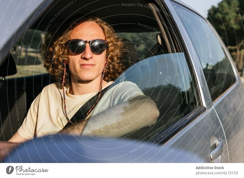 Man in sunglasses driving car man drive style automobile window confident trendy male young serious driver vehicle eyeglasses eyewear hair lifestyle transport