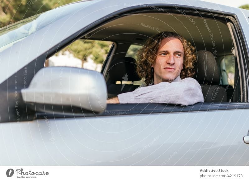 Man driving car on countryside man drive style automobile window confident trendy male young driver vehicle hair lifestyle transport trip travel handsome