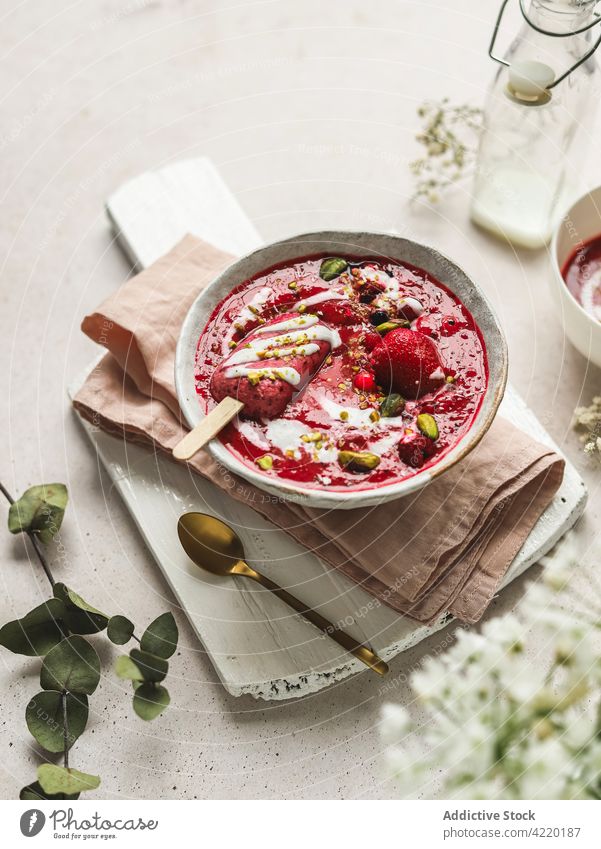 Delicious smoothie bowl with popsicle and pistachios for breakfast berry dessert healthy food treat sweet delicious yogurt tasty fresh ice candy vitamin ice pop