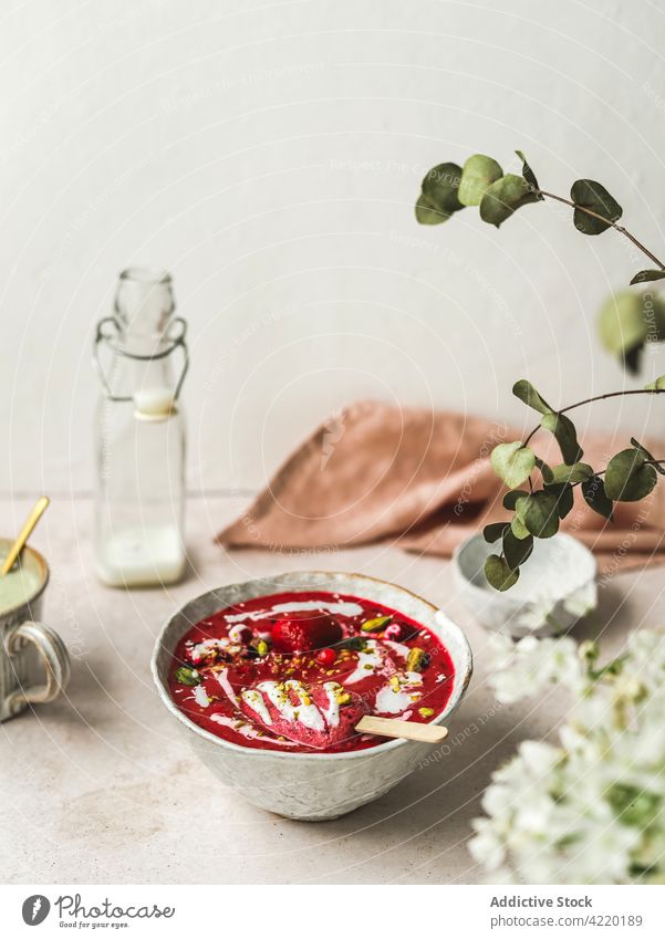 Delicious smoothie bowl with popsicle and pistachios for breakfast berry dessert healthy food treat sweet delicious yogurt tasty fresh ice candy vitamin ice pop