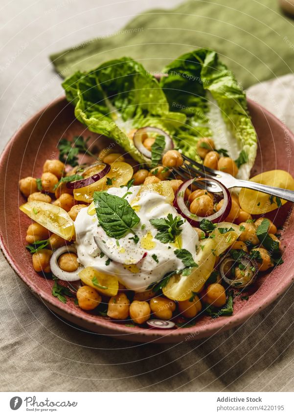 Tasty chickpea with cheese and vegetables on plate dish burrata appetizing serve food delicious cuisine meal tasty gourmet mozzarella onion yellow tomato