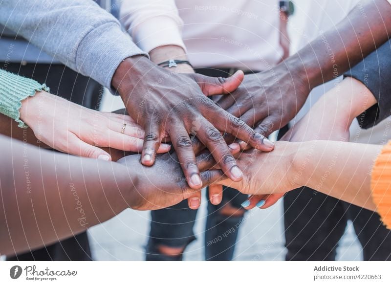 Crop multiracial protesters putting hands together in daytime stack hands support black lives matter unity human rights justice movement group women people blm