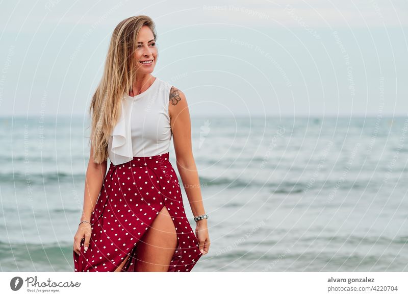 young woman alone in front of the sea in a cloudy summer day beach ocean girl sky beautiful clouds season water vacation beauty female hat relax people travel