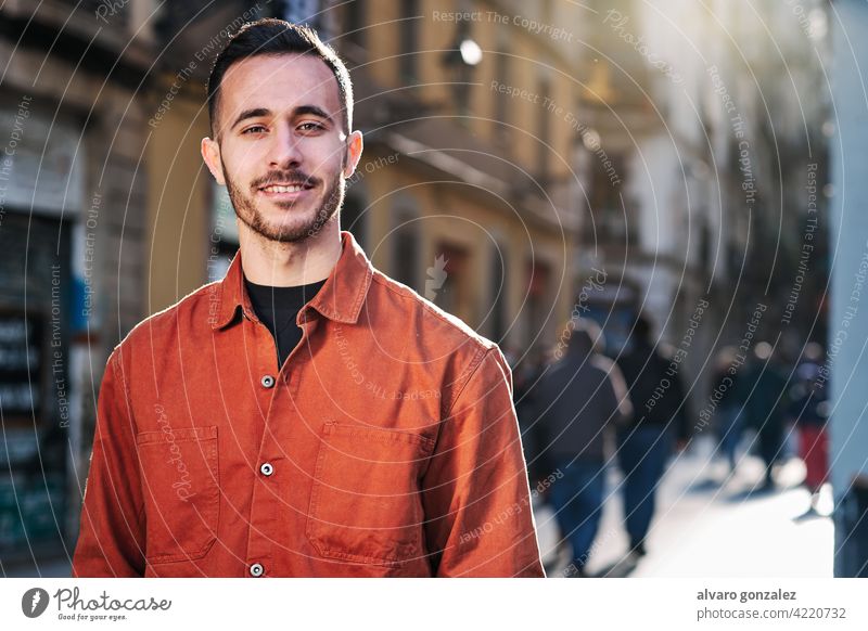 Man standing outdoors on the street. che portrait urban city confidence people one face smiling posing town smile looking outside confident style person male